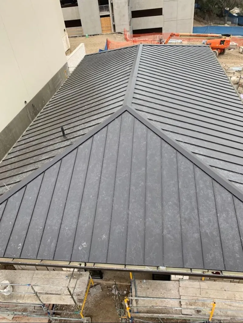 Commercial metal roof construction with crane equipment in Mount Vernon